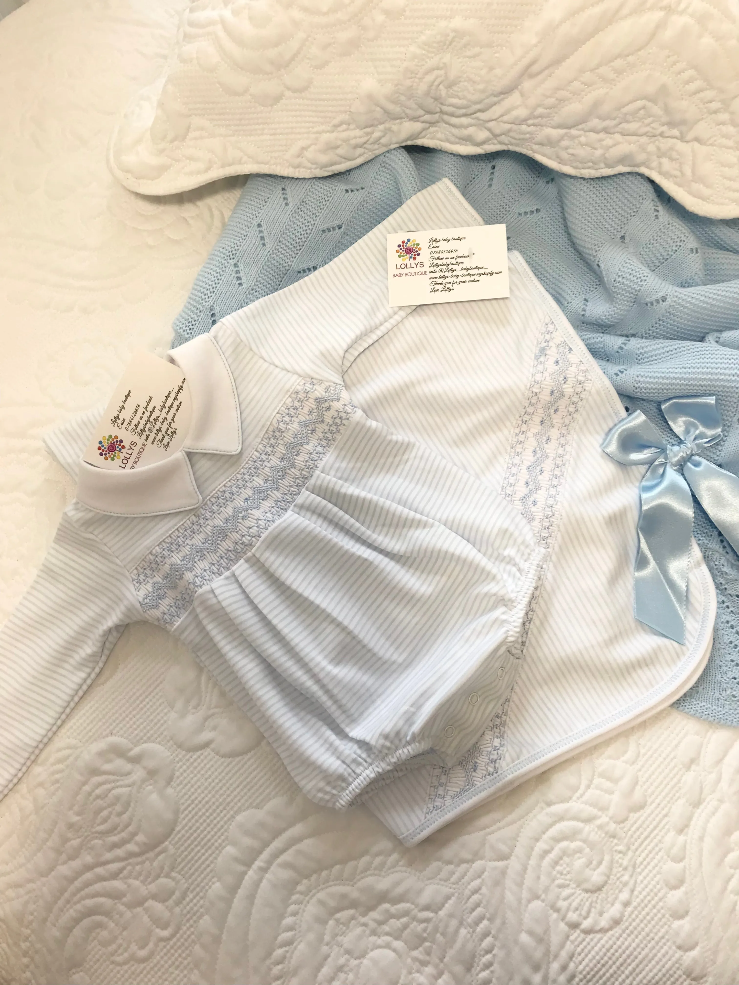 Baby boys magnolia Smocked romper blue and white .